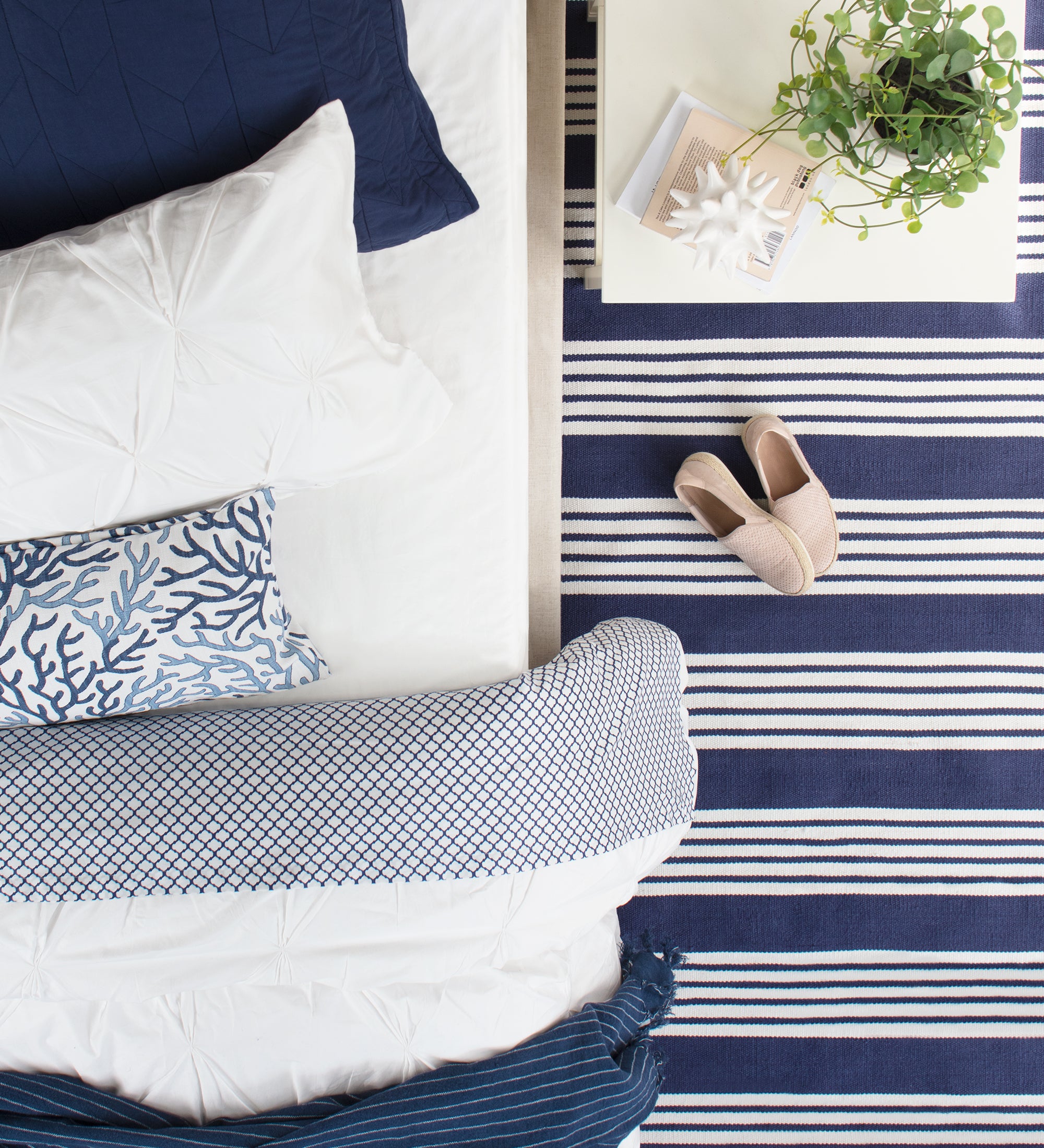 Blue and White Bedding and Striped Rug